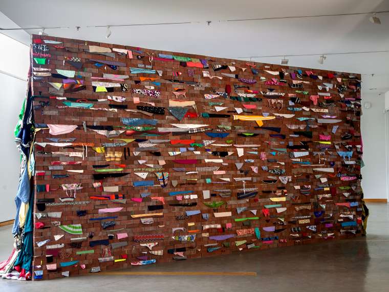 Karyn Olivier, Wall, 2017–2018. Bricks, used clothing, steel. Courtesy of the artist.