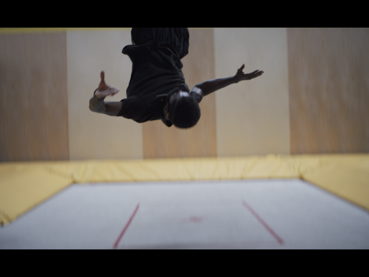 Acrobat Austin Bradley filmed by Nicole Miller for A Sound, a Signal, the Circus, 2021 (still). Mixed-media installation. Image courtesy of the artist and Kristina Kite Gallery, Los Angeles.