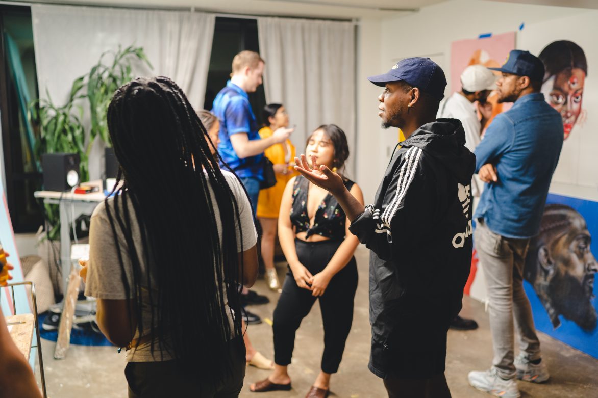 People in a room having a conversation.