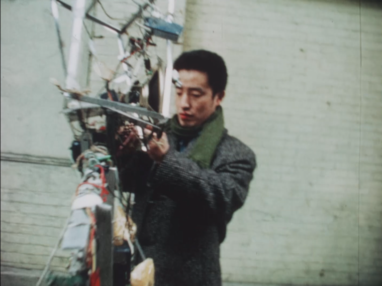Nam June Paik with Robot K456 in NYC, 1964, screenshot from film, Courtesy of Electronic Arts Intermix (EAI), New York and the Estate of Nam June Paik © The Estate of Nam June Paik