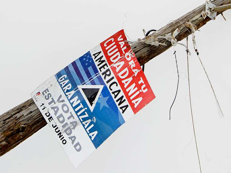 Gabriella Torres-Ferrer, Untitled (Valora tu mentira americana) (detail), 2018. Hurricane ravaged wooden electric post with statehood propaganda, 116 × 118 × 122 in. Private collection; courtesy the artist and Embajada, San Juan