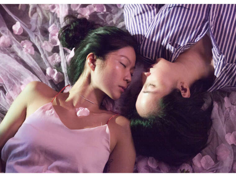 Ele and Lee lie facing each other. The two don’t prioritise official marriage, although they do see themselves in a long-term partnership, and imagine a life together outside of Singapore. They do not consider gender roles important in their relationship, which they see as egalitarian. 2018.