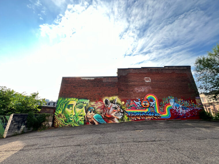 Tikay, Dakpak de la Selva, Melon James, Pilster and Gonzales mural on Penn Avenue. June 2024. (Pittsburgh, PA). Spraypaint and acrylic paint on brick. Approx 20 by 100 feet. Curated by Hemispheric Conversations Urban Art Project Visiting Artist Residency. Photo credit: Shane Pilster.
