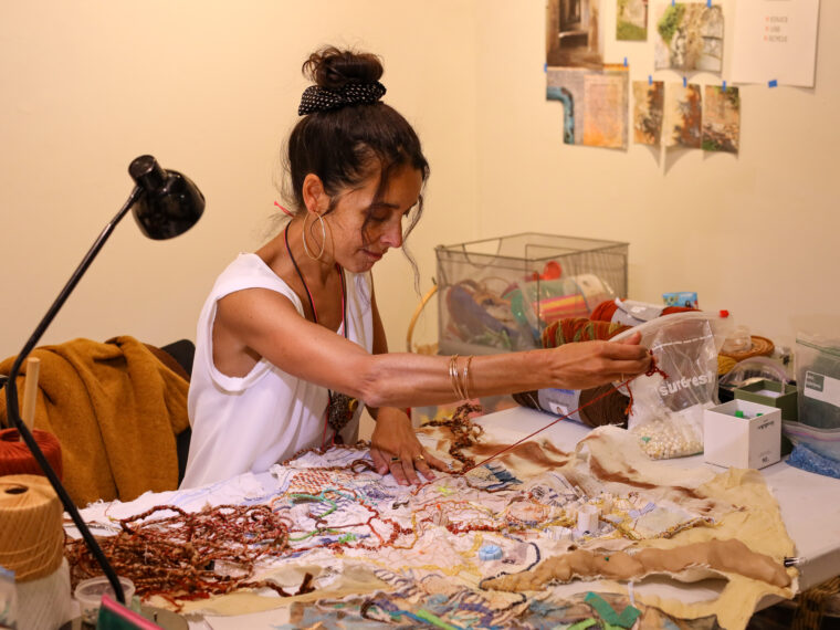 Patrizia Ferreira, 2024 North Carolina Emerging Artist in Residence works on a fiber arts piece in her studio. Photo courtesy of Sanjé James.