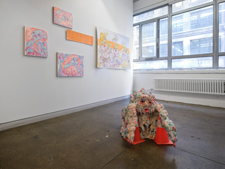 Installation by DW Zinsser. Left to Right: nug I, 2025. Pen and acrylic on paper on panel. 12 x 16 inches. nug II, 2025. Pen and acrylic on paper on panel. 18 x 24 inches. nug III, 2025. Pen and acrylic on paper on panel. 16 x 12 inches. Grout Pout, 2024. Pen and acrylic on paper. 40 x 60 inches. nug spore, 2025. Epoxy clay, gloss medium, waterslide decals, bouncy balls, traffic cones, acrylic, found objects. 30 x 48 x 30 inches. 